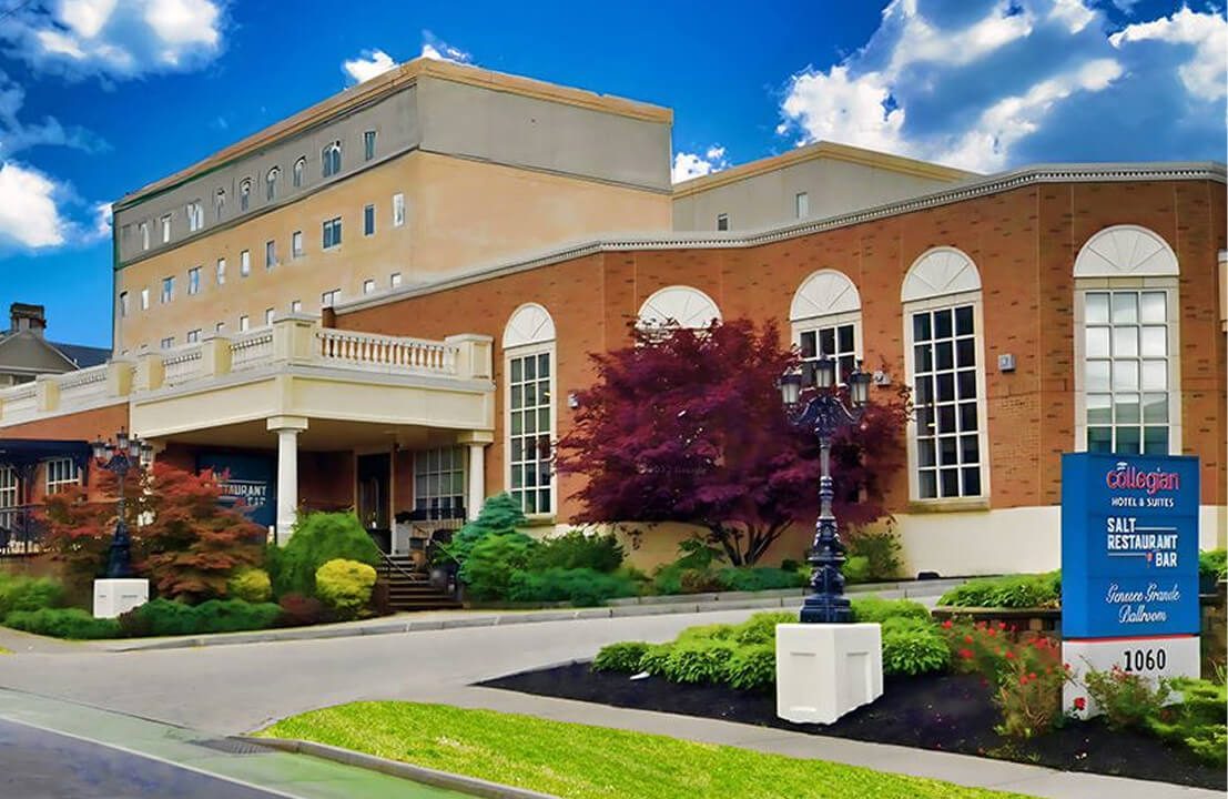 Brick hotel building with landscaped entrance.