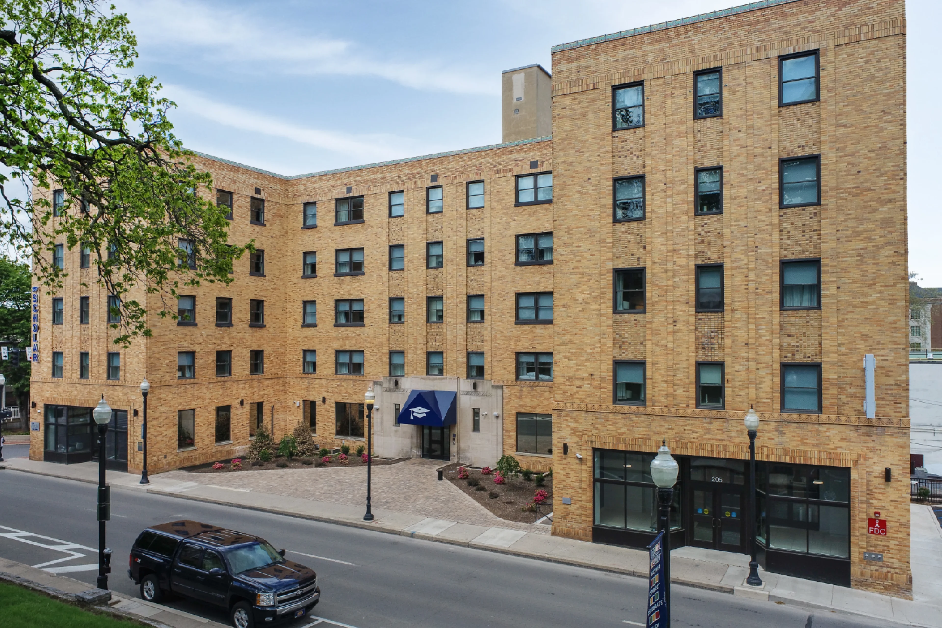 Brick building with multiple windows and entrance.