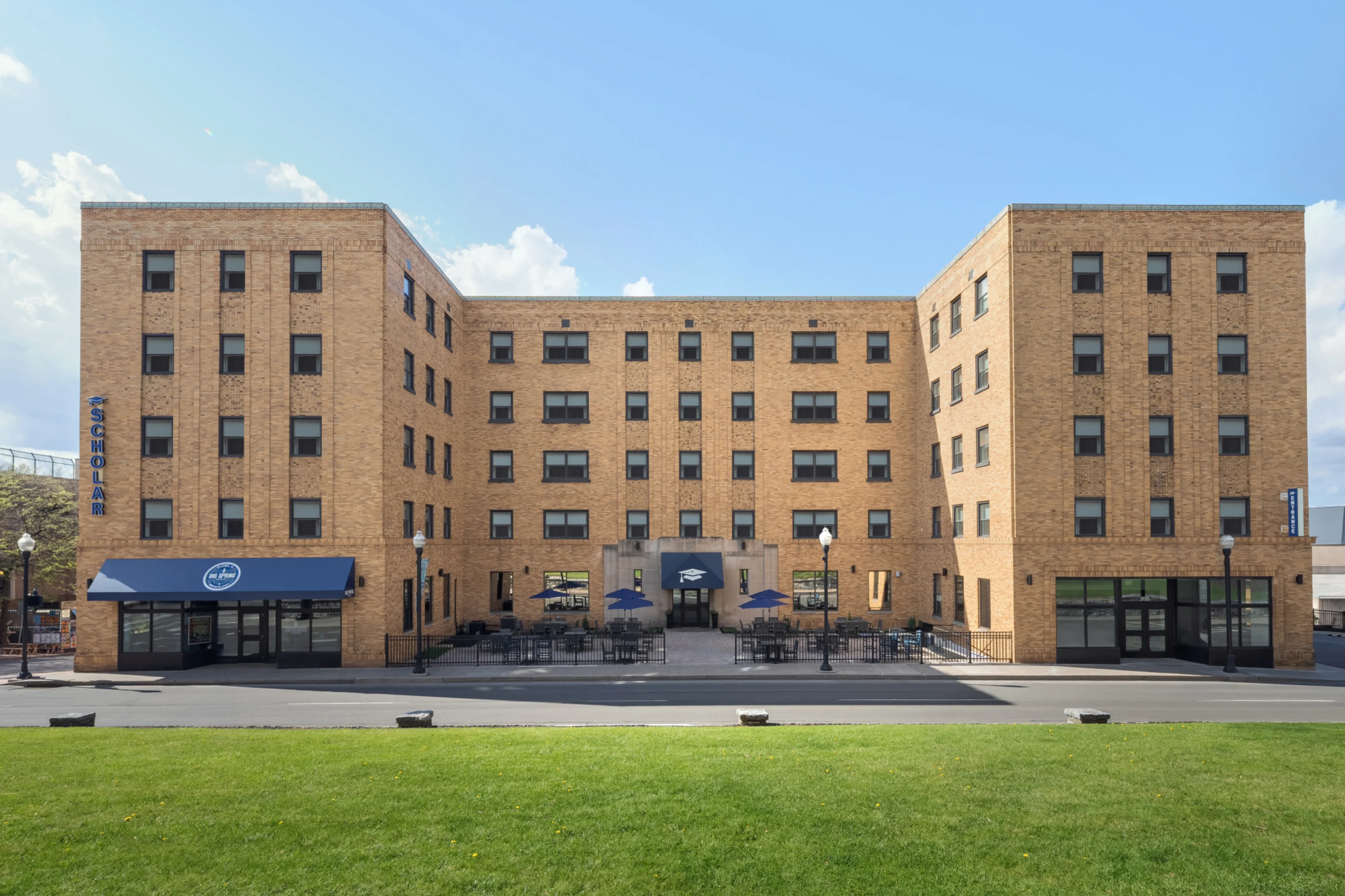 Brick building with outdoor seating area.