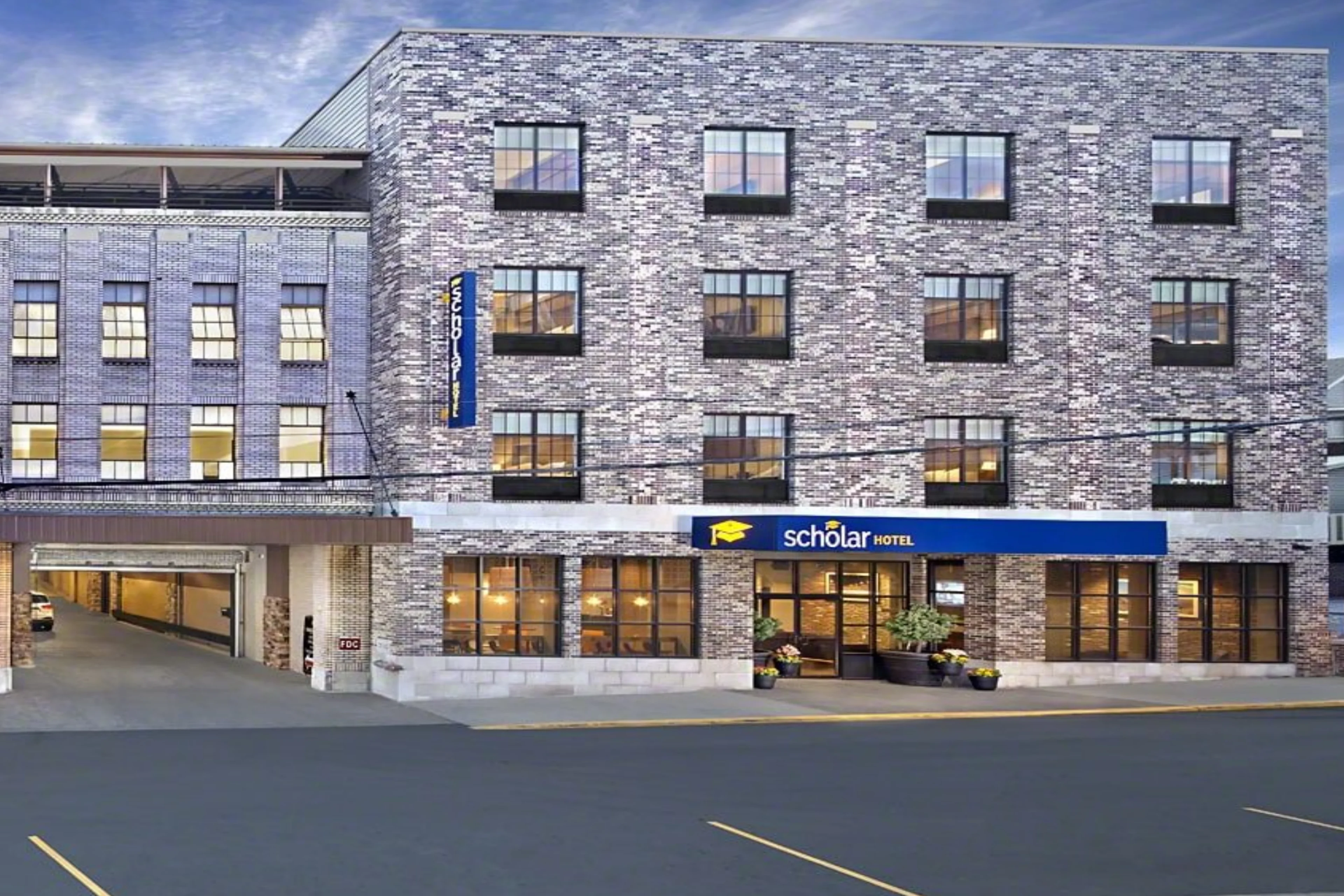 Brick building with Scholar Hotel signage.