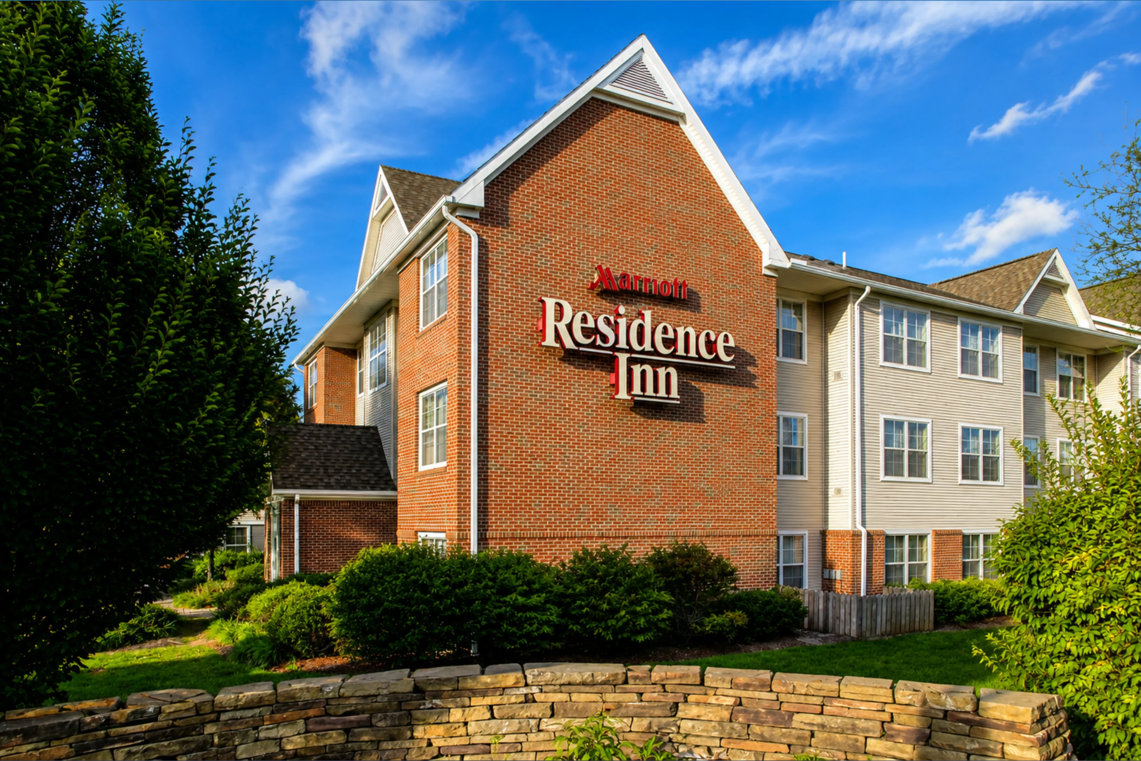 Residence Inn hotel exterior with greenery.