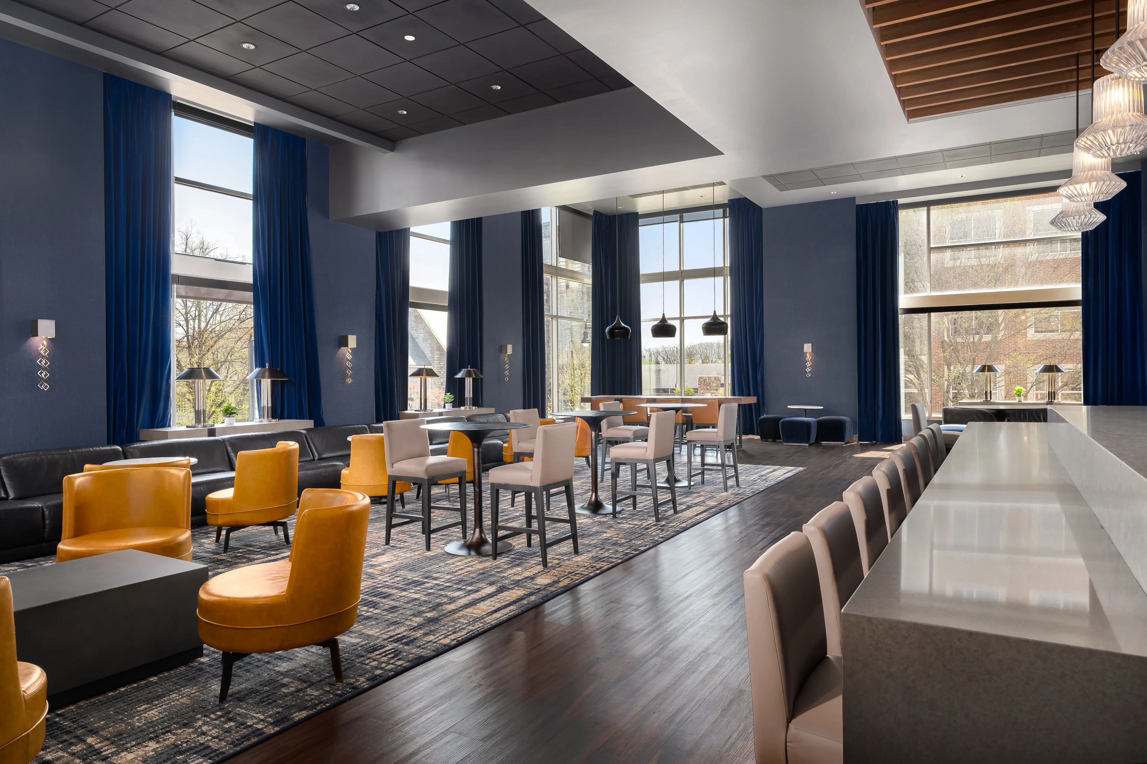 Modern lounge with yellow and white chairs.