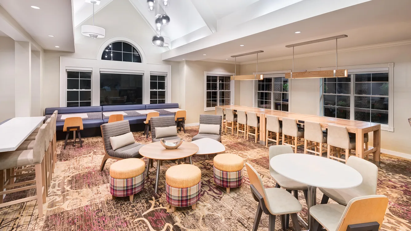 Modern lounge area with seating and tables.
