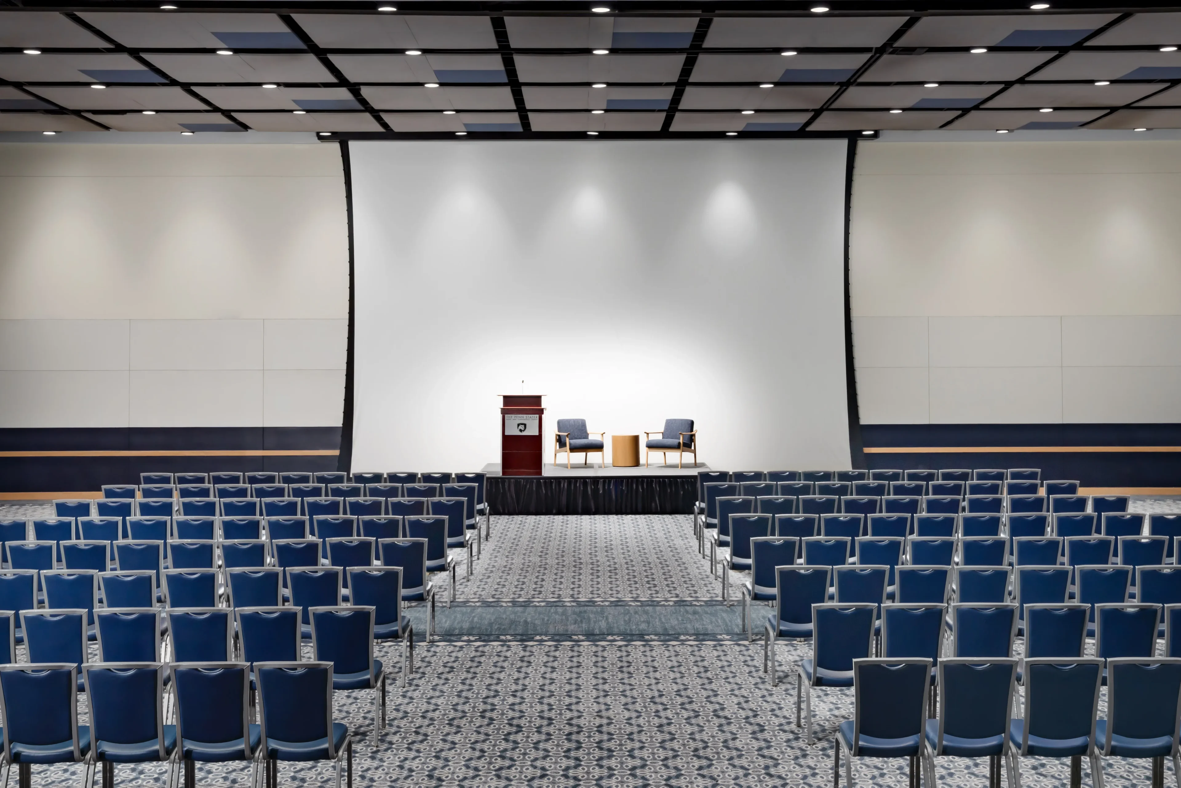 Empty conference room with chairs and stage.