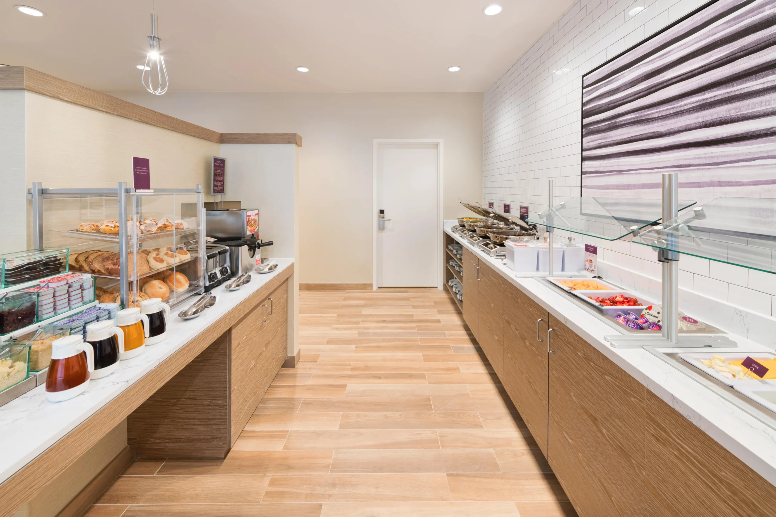 Hotel breakfast buffet with various food options.