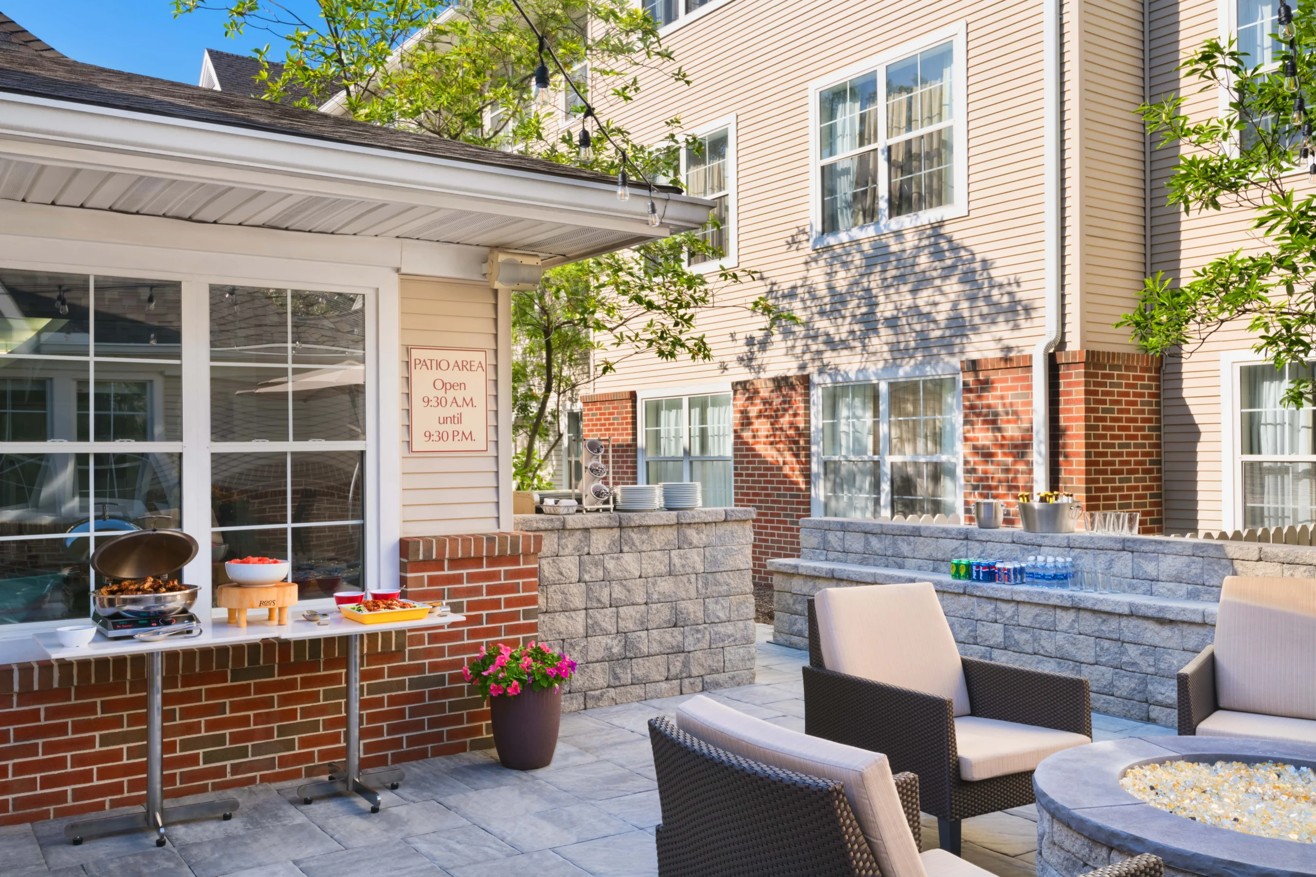 Outdoor patio with chairs and barbecue grill.