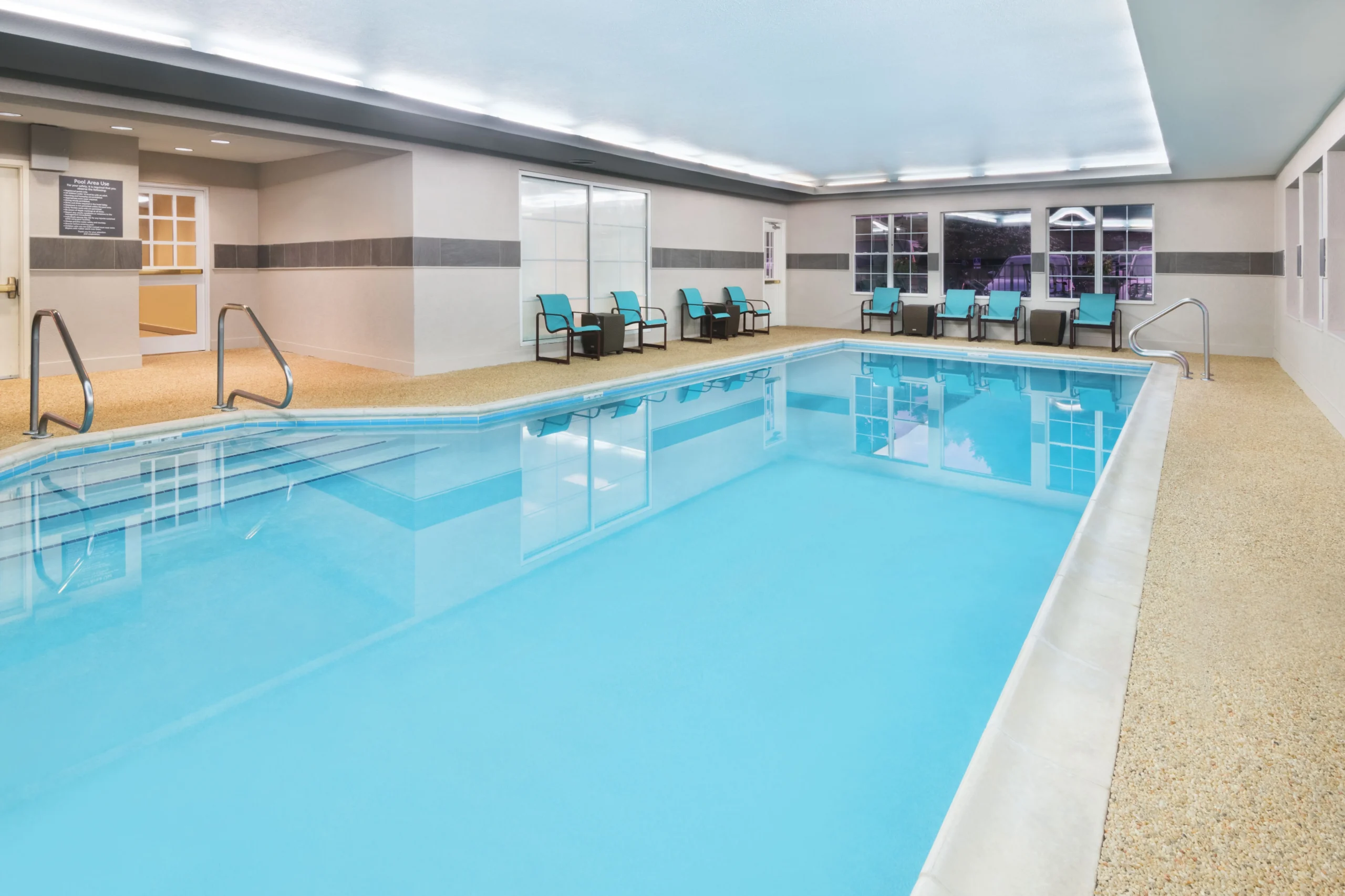 Indoor swimming pool with lounge chairs.