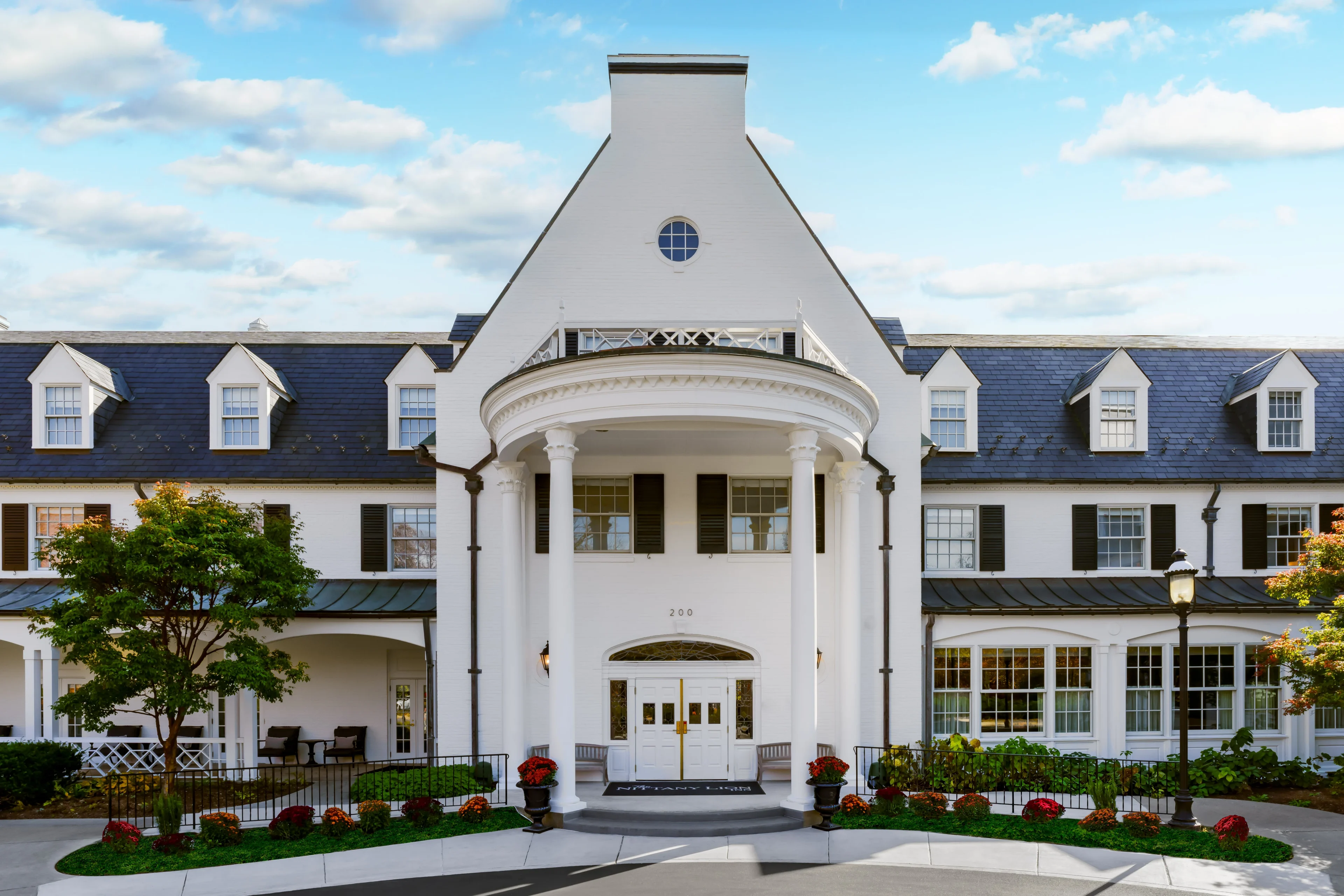 Elegant white building with columns and windows.