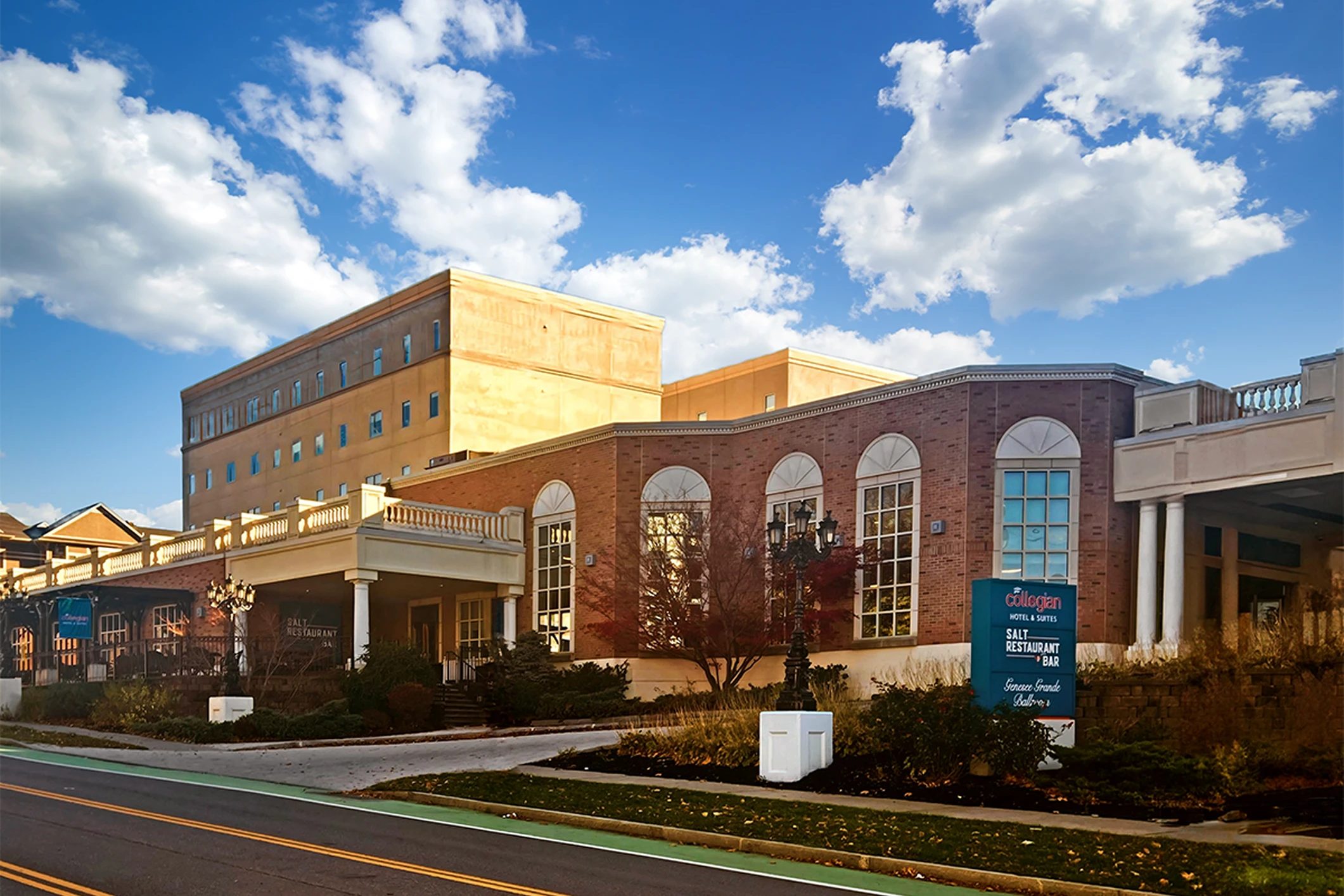 Brick building under a blue cloudy sky.