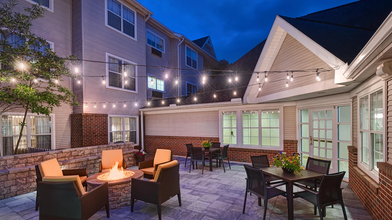 Cozy patio with string lights and seating.