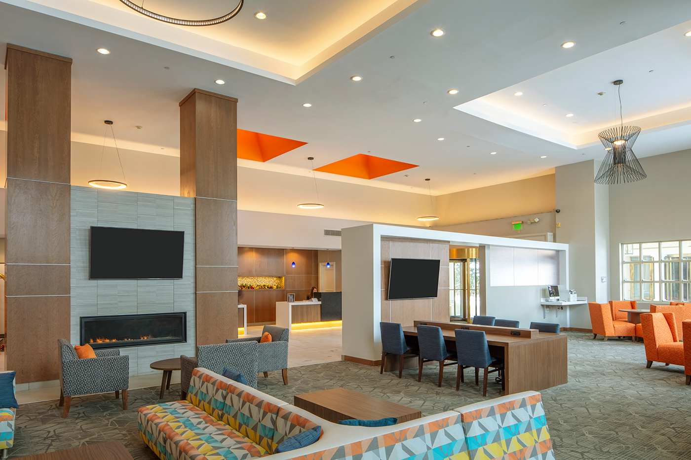 Modern hotel lobby with colorful seating area.